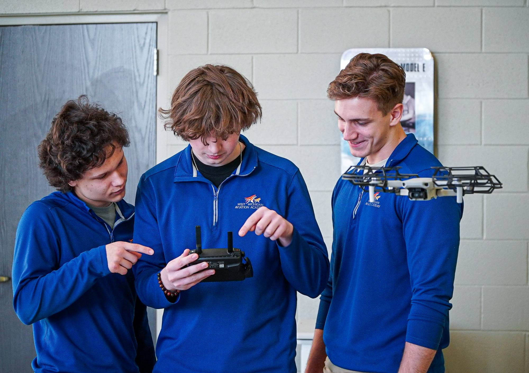 Student working together on operating a drone